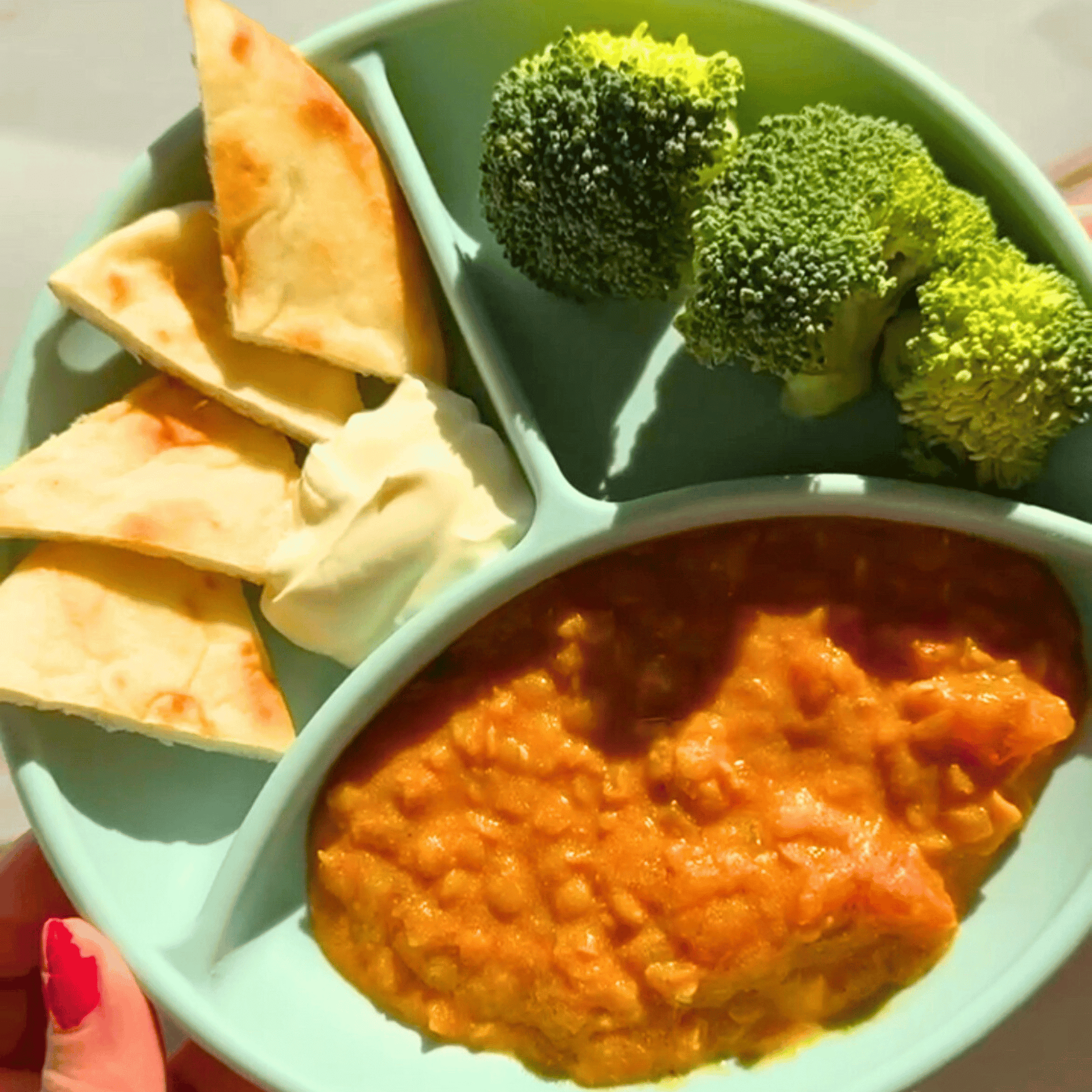 Red lentil curry for babies served with pita bread and broccoli 