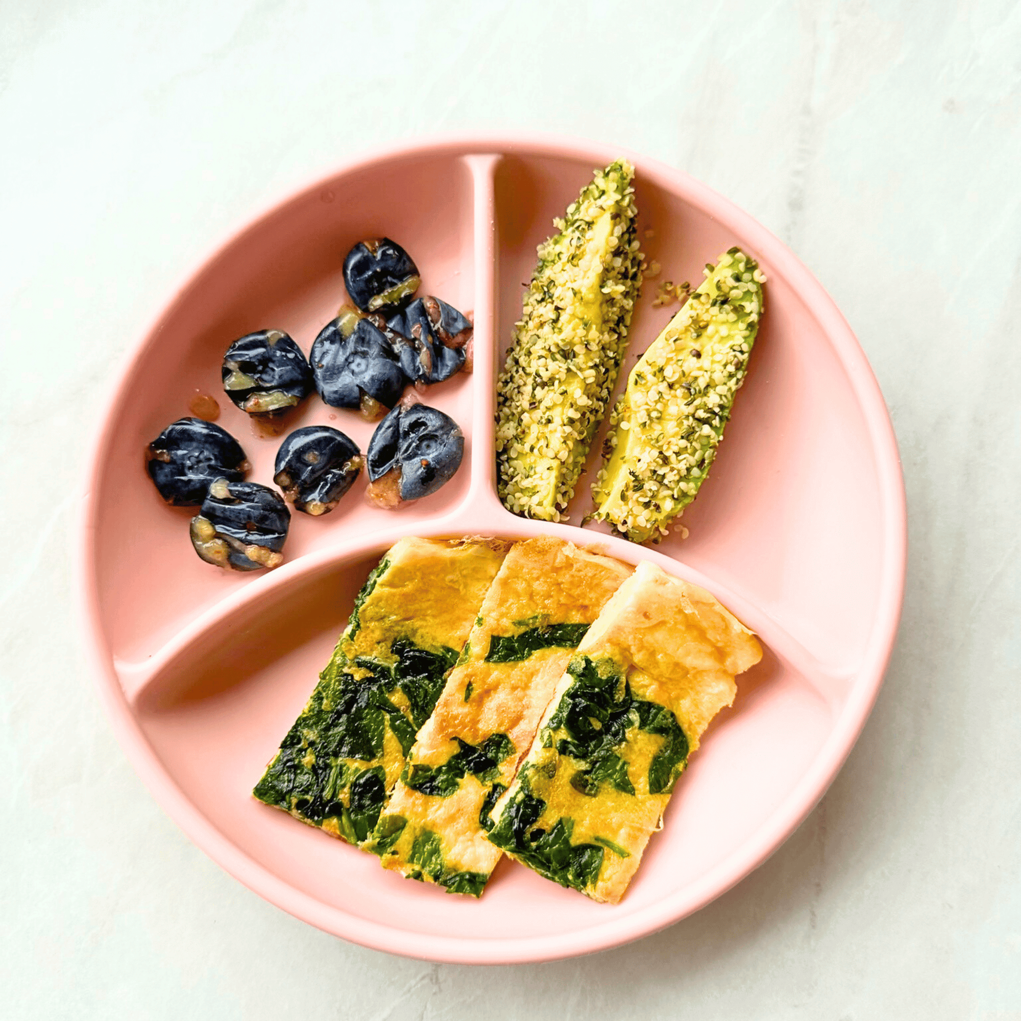 BLW Plate with Spinach & Cheese Omelette Fingers, squashed blueberries and avocado slices rolled in hemp seeds